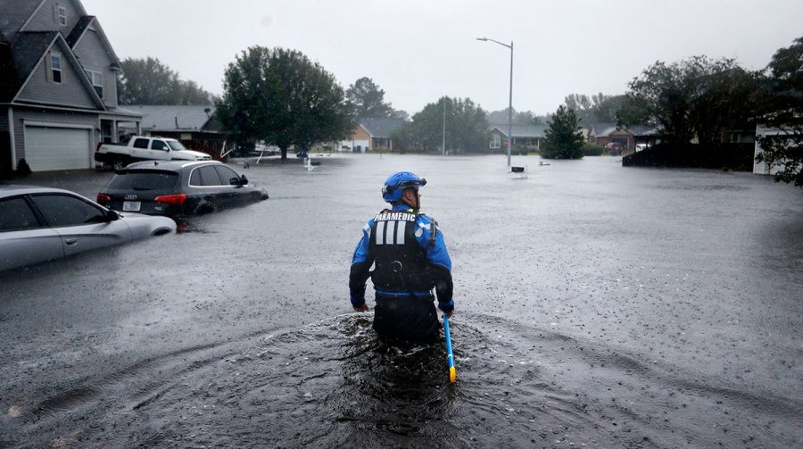 A member of the North Carolina Task Force rescue team surveys flooding in Fayetteville, N.C. on Sept. 16. (David Goldman/AP)